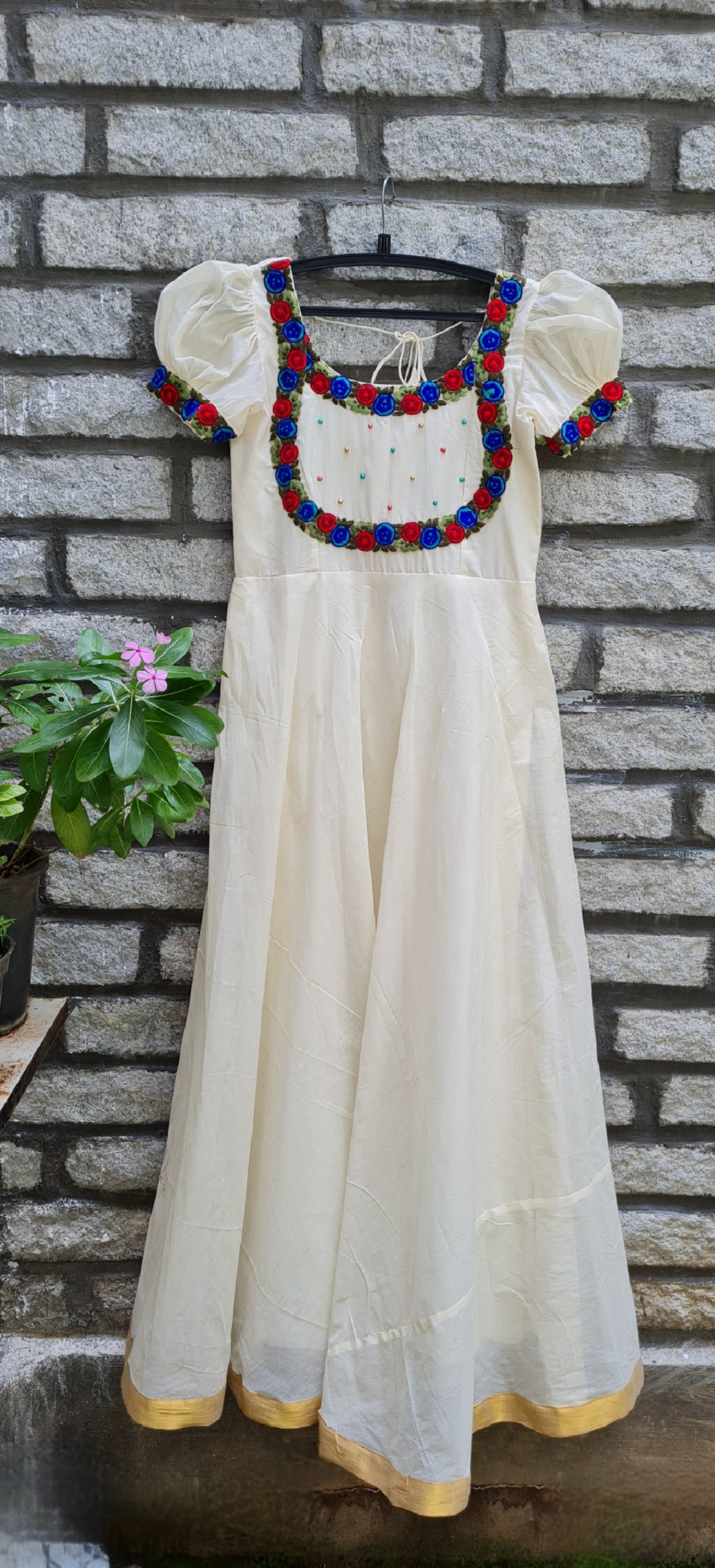 Onam Opulence: Off-White Umbrella Cut Frock with Red and Blue Embroidery